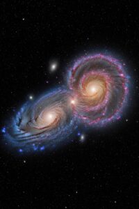 Two massive spiral galaxies colliding in deep space with blazing star formation clouds
