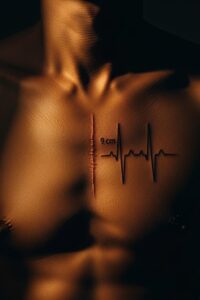 Close-up of a father's chest tattoo replicating his child's open heart surgery scar