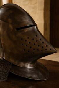 Medieval hounskull bascinet helmet with chainmail aventail resting on dark walnut table