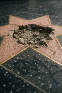 Trump's Hollywood Walk of Fame star smashed open showing broken pink terrazzo and rubble