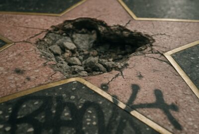 Smashed and graffiti-covered Donald Trump Hollywood Walk of Fame star on Boulevard sidewalk