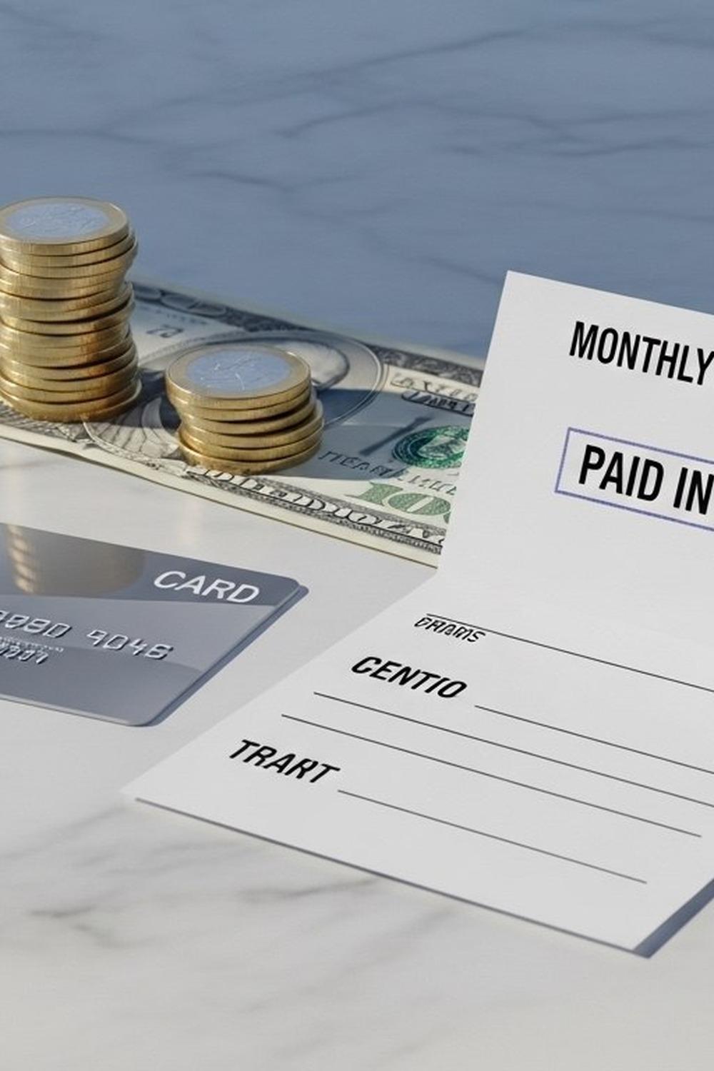 A cut credit card resting on a monthly statement showing zero interest charged