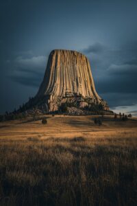 Devil's Tower rising dramatically from flat Wyoming prairie under a wide open sky