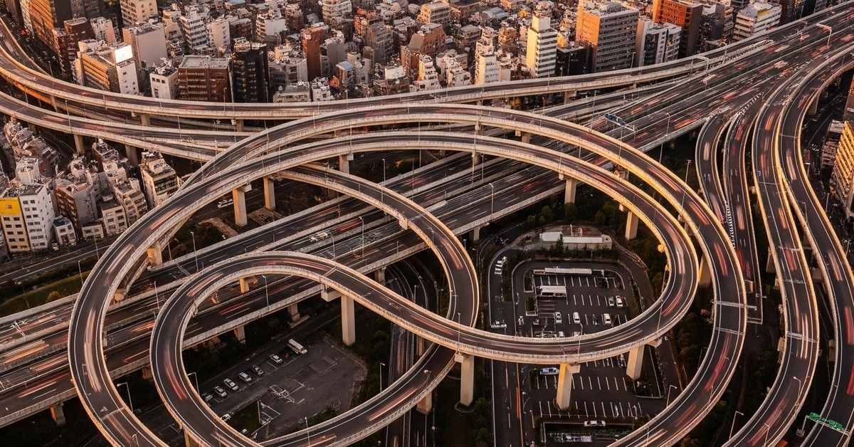 Aerial view of packed multilevel Tokyo highway interchange at golden hour
