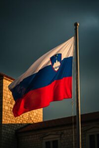 Slovenian flag flying boldly against a dramatic stormy European sky at dusk