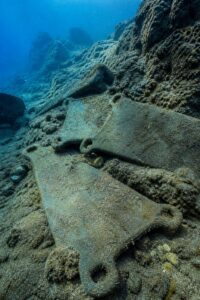 Bronze Age oxhide tin and copper ingots recovered from the Uluburun shipwreck, resting on the seabed